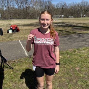 Female high school winner holding her medal.